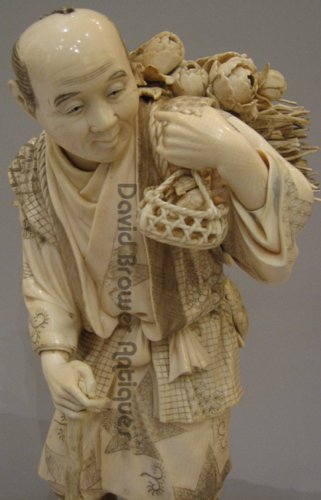 A Large Japanese Ivory Okimono of a woodcutter